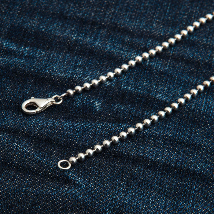 A close-up of the secure lobster clasp on the 3mm silver ball chain.