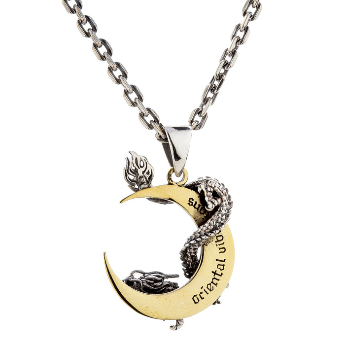 The back of the dragon moon pendant on a chain, showing the engraved text on the moon.