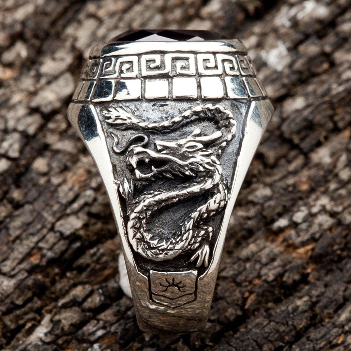 A side view of the men's silver ring showing the detailed carving of an Eastern dragon.