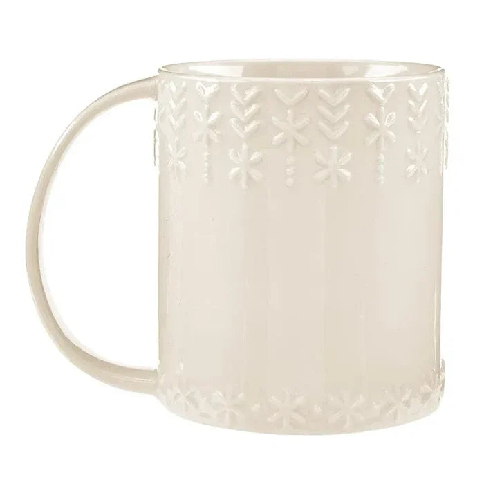 Cream-colored ceramic embossed holiday mug with snowflake and leaf patterns for festive use