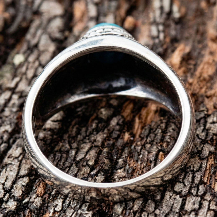 View of the inside of the ring band, highlighting the smooth polish and thickness.