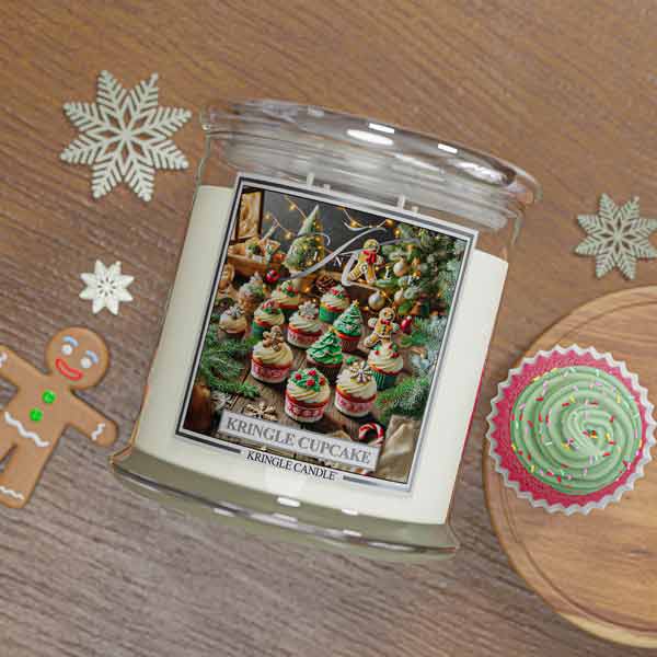 Kringle Candle jar with Christmas-themed design on a wooden surface with decorative elements.
