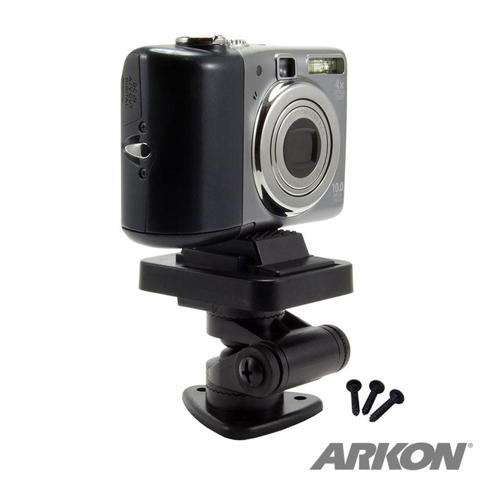 A digital camera is mounted on the Multi-Angle Adhesive or Drill Base Mount with a 1/4-20 camera mounting pattern in black, accompanied by three screws. The ARKON logo is visible in the bottom right corner.