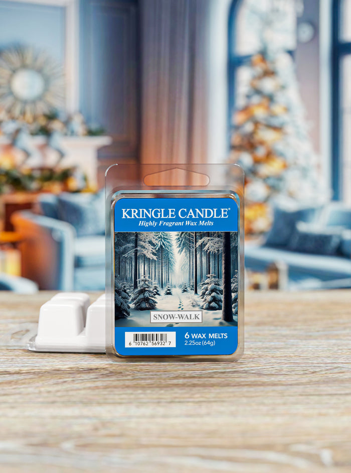 Kringle Candle wax melt package on a wooden surface with a blurred festive background