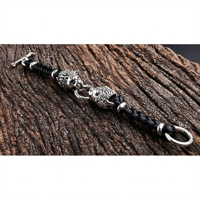 Full length view of sterling silver lion head braided leather bracelet laid flat on rustic wood