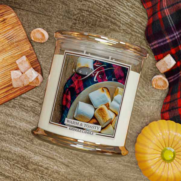 Kringle Candle 4-wick jar with marshmallows and a pumpkin on a textured surface