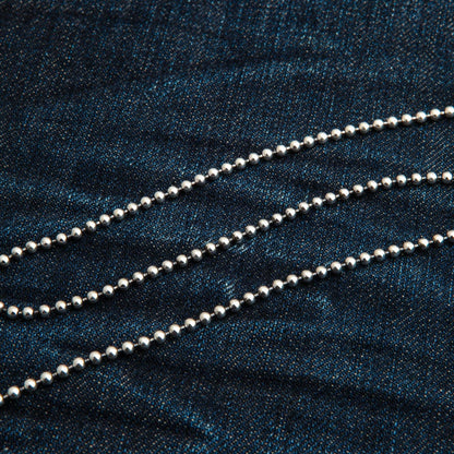 A close-up of the 3mm silver beads on the ball chain necklace.