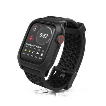 The Catalyst Case US 40mm Rugged Case + Band for Apple Watch Series 6/5/4/SE (Gen 2/1) in sleek black showcases the time, date, weather, and heart rate. It stands upright on a reflective surface with a scattered glass effect below.