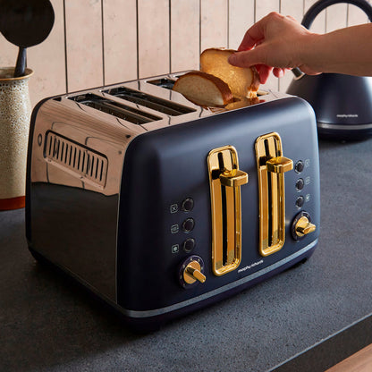 Blue toaster with gold accents on a kitchen counter, being used to toast bread.