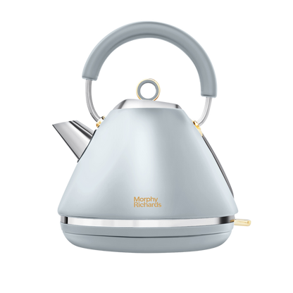 A Morphy Richards Accents Gold Pyramid Kettle in ocean grey with classy gold accents and a pyramid silhouette.