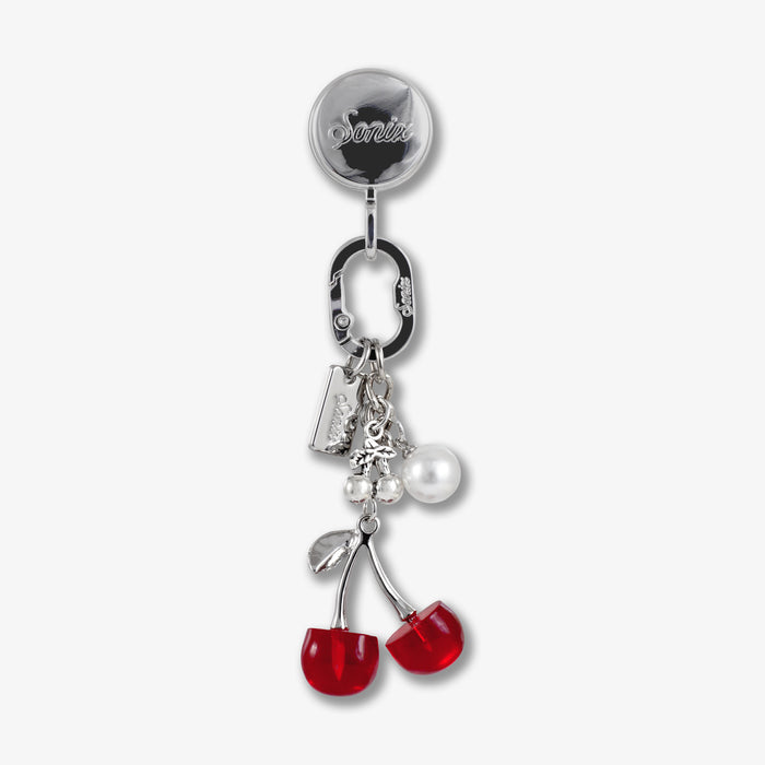 Close-up of Adhesive Phone Hook with red cherry charms showing silver reel and carabiner on white background