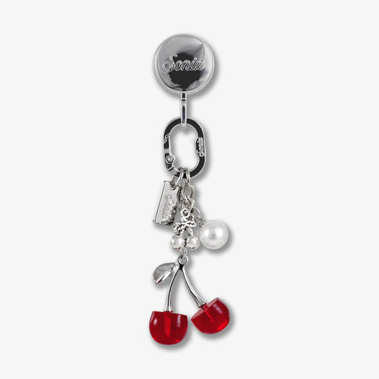 Close-up of Adhesive Phone Hook with red cherry charms showing silver reel and carabiner on white background