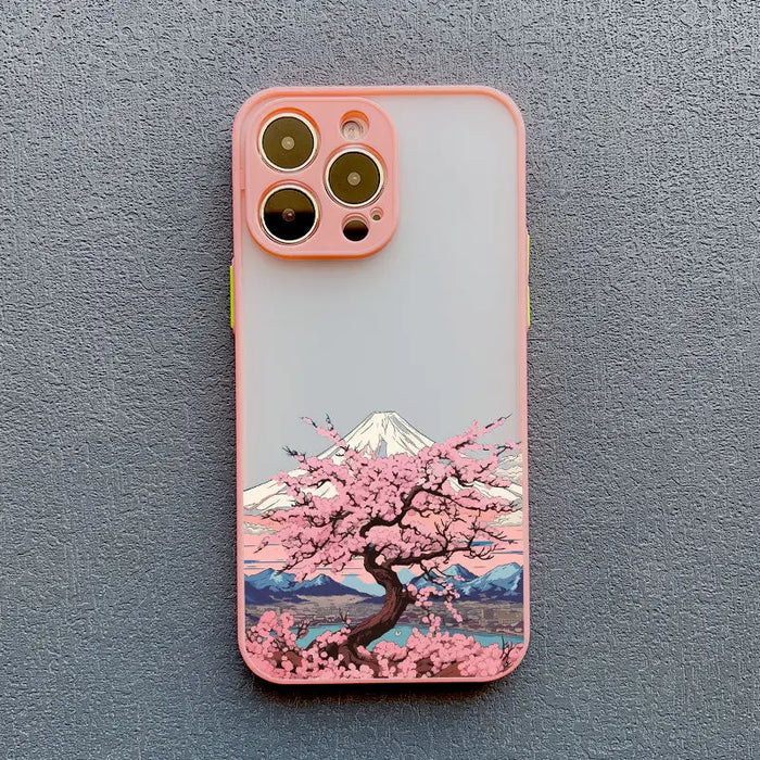 a pink phone case with a cherry blossom tree on it