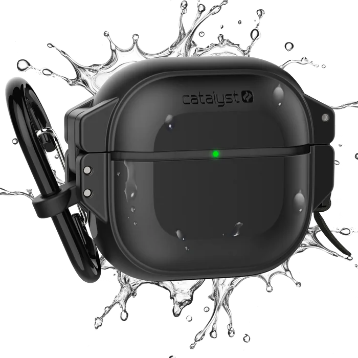 A black Catalyst Case US AirPods 4 - 100M Waterproof Total Protection Case + Carabiner with green LED indicator is shown splashed by water, highlighting rugged, military-grade durability. The white background emphasizes its tough, waterproof design.