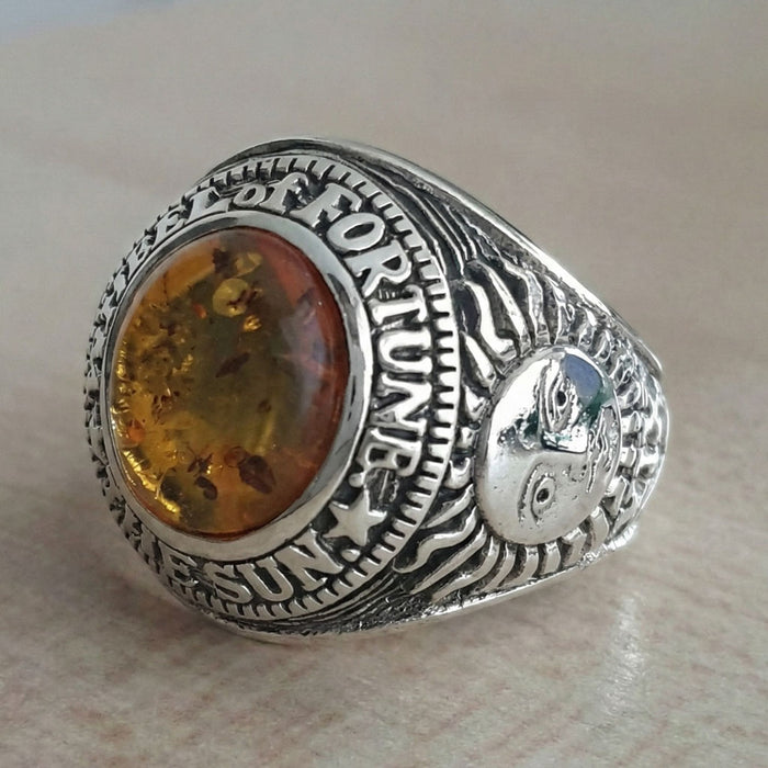 The side of the silver tarot ring showing the detailed carving of The Sun card (Major Arcana XIX).