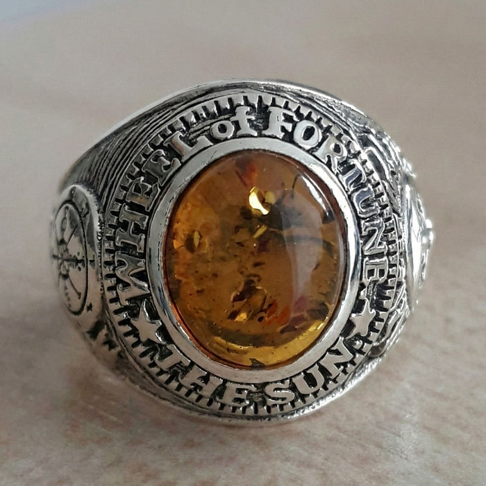 The side of the esoteric ring showing the compass-like Wheel of Fortune symbol (Major Arcana X).