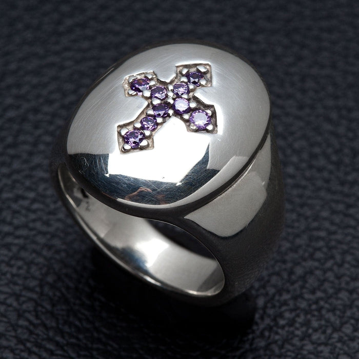 Angled view showing the high-polish mirror finish of the silver and the faceted purple stones.