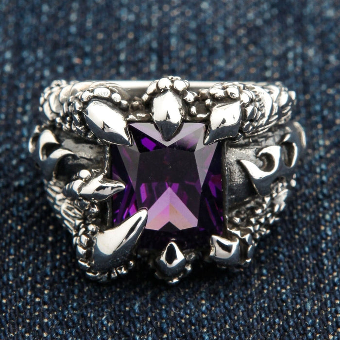 A front view of the amethyst claw gothic ring in sterling silver, showing the purple CZ stone held by eagle talons.