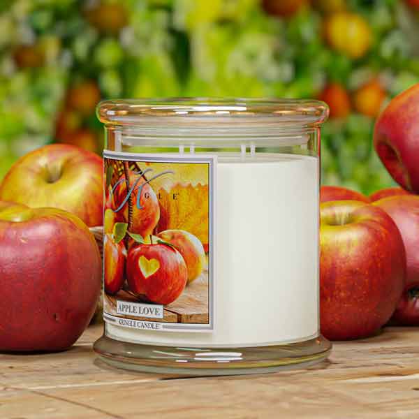 4-wick Candle jar with 'Apple Love' label surrounded by apples on a wooden surface