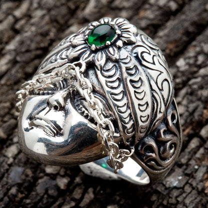A tribal face ring handcrafted from silver, with a unique draped chain accent across the cheeks.