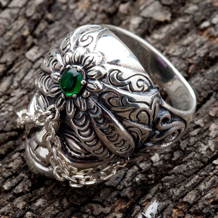 A handcrafted Balinese-style silver ring with a detailed face and a comfortable, solid band.