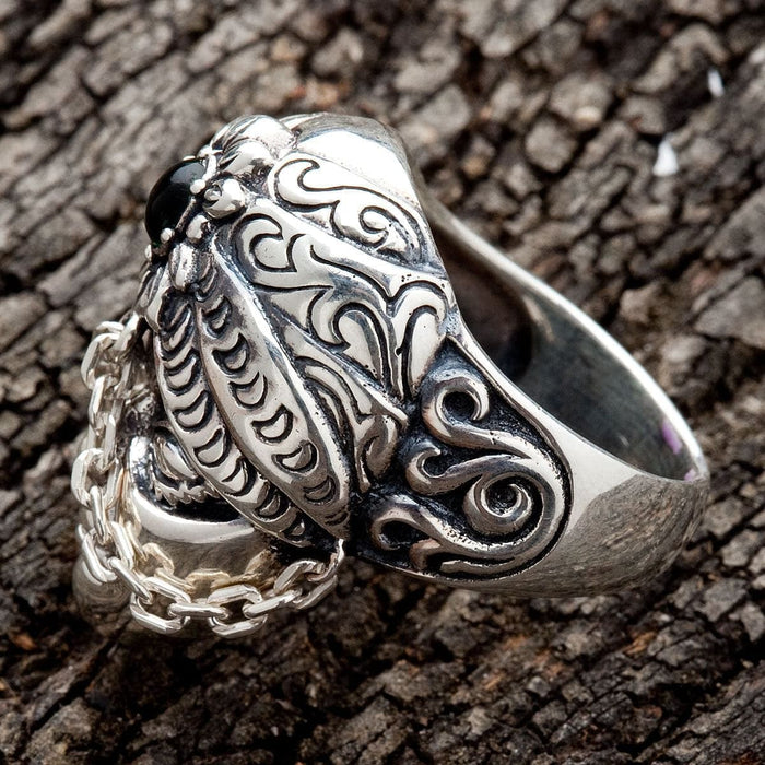 The side profile of the Bali face ring, highlighting the intricate scrollwork on the band.