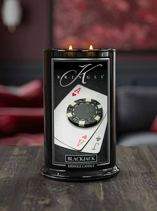 Kringle Candle with poker chip and card design on a wooden surface