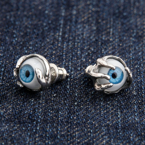 A pair of blue eyeball stud earrings in sterling silver, clutched by a gothic claw design.