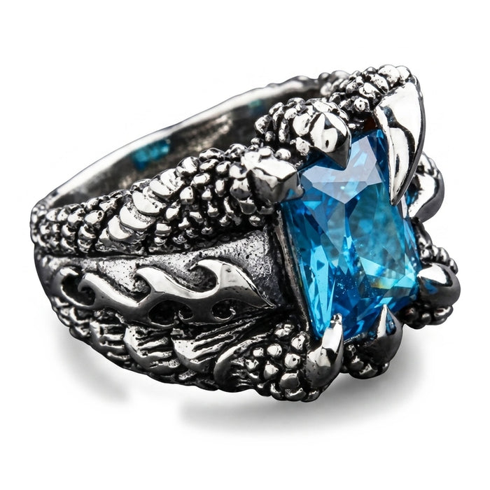 Right-side angle highlighting the rectangular blue topaz facets framed by sculpted eagle talons