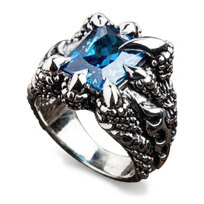 Top-down angle looking onto the blue topaz held by four eagle talons above the flame-carved band