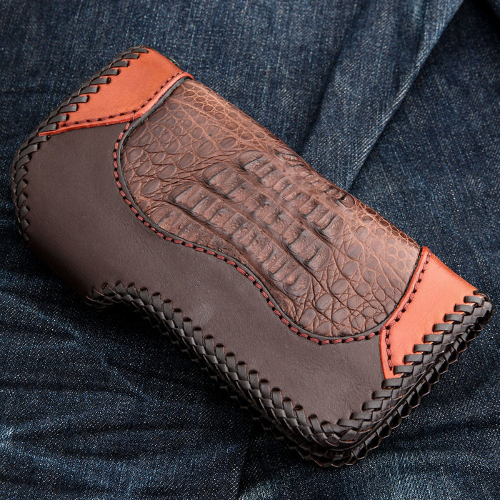 Crocodile panel set between smooth reddish-brown ends, dark whipstitching round the edge and red seams between.