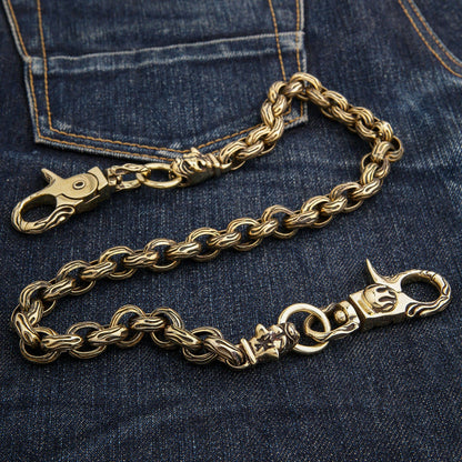 An angled view of the handcrafted, thick 16mm brass wallet chain.