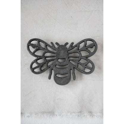 Stylized cast aluminum bee trivet with intricate wing patterns for home decor
