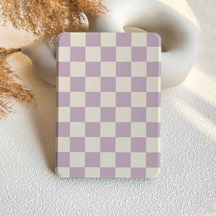 A Kindle case with a purple and white checkerboard pattern displayed on a neutral background.