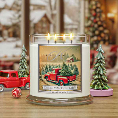 Kringle Candle with Christmas tree farm design featuring a red truck and trees on a snowy background.