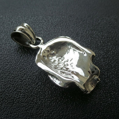 The back of the solid silver skull pendant, showing its hollow construction and ornate bail.