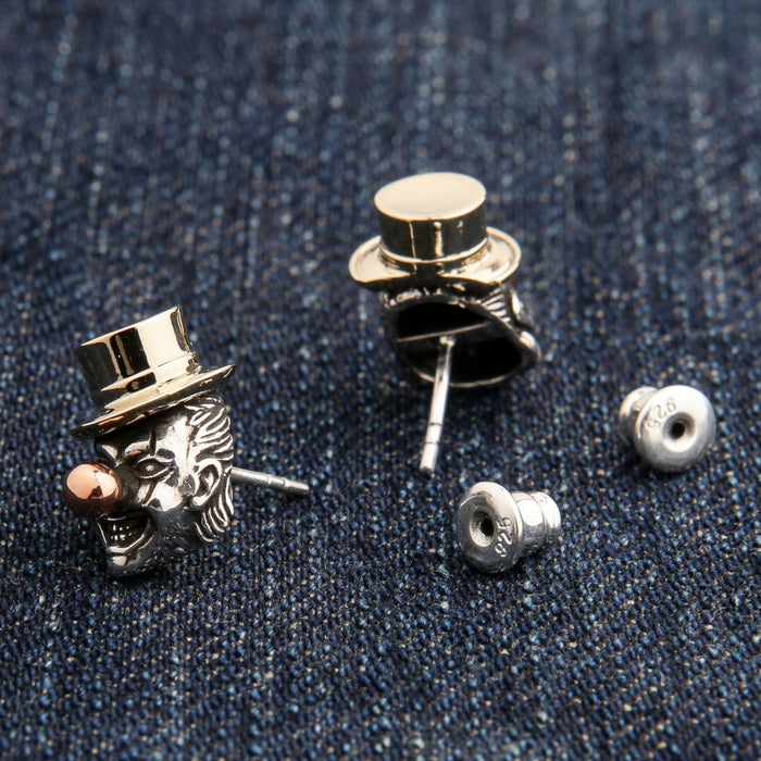The pair of gothic clown earrings separated to show the post and back individually.