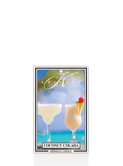 Label with two coconut coladas in glasses against a tropical beach backdrop. Text reads "Coconut Colada" and "Kringle Cand…