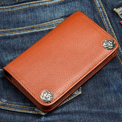 A premium, high-quality cowhide leather wallet in cognac brown, shown resting on the back pocket of a pair of blue jeans.