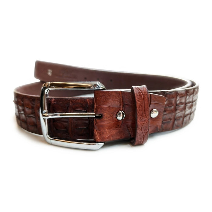 Angled view of the cognac crocodile belt's polished silver prong buckle, leather keeper loop and twin rivets