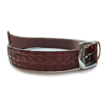 Side profile of the crocodile belt with silver prong buckle and the punched adjustment holes along the billet