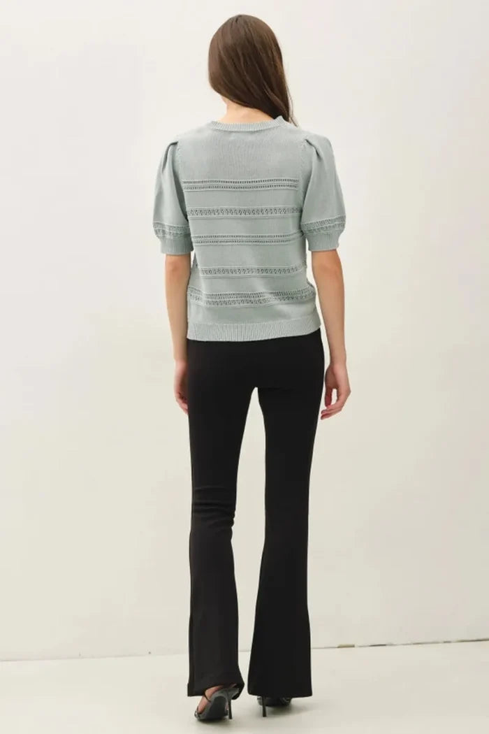 Light gray knitted crochet striped puff sleeve sweater with short puffed sleeves and lace-trimmed horizontal bands