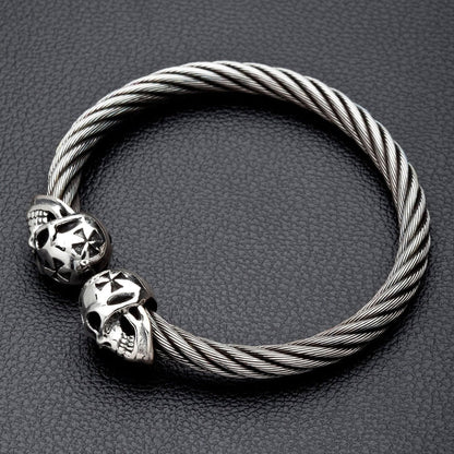 Angled view of the men's skull cuff bracelet on a black leather surface.