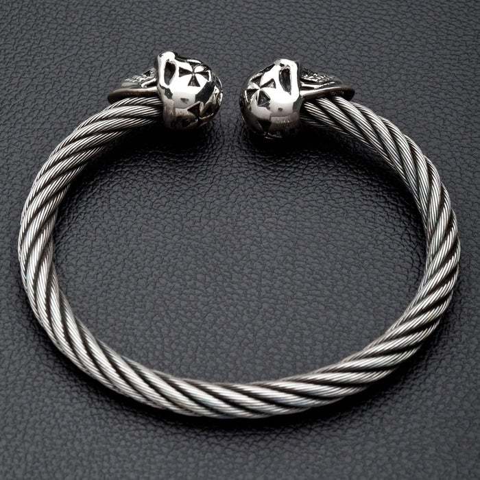 A studio shot of the full twisted cable cuff bracelet with silver skulls.