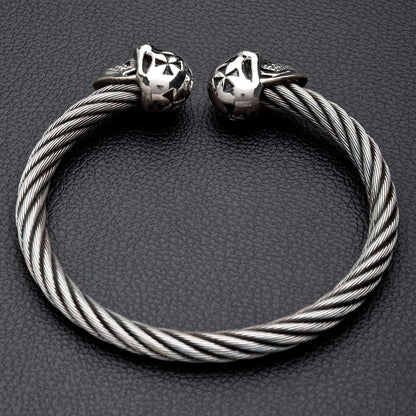 A studio shot of the full twisted cable cuff bracelet with silver skulls.