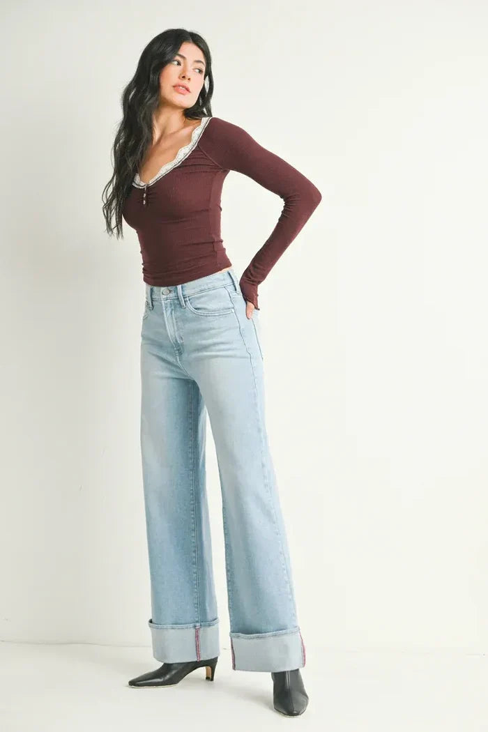 Woman wearing cuffed high rise palazzo jeans and a long-sleeved top