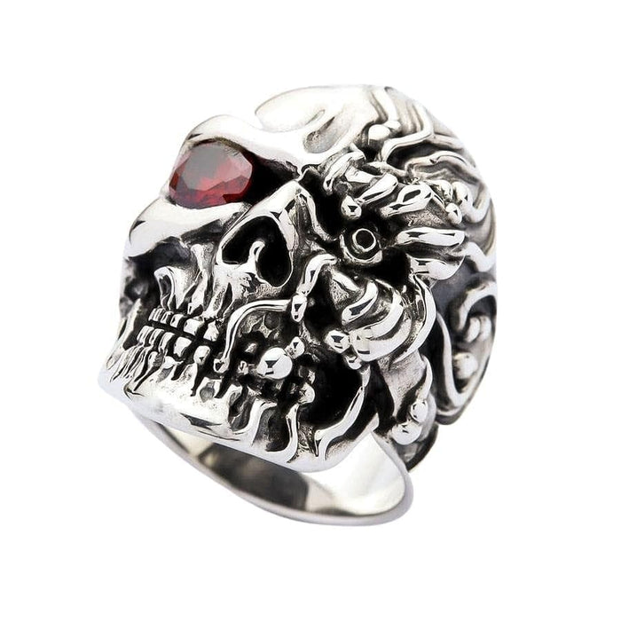 Three-quarter angle of cyborg skull ring highlighting mechanical overlapping plates and ruby gemstone eye