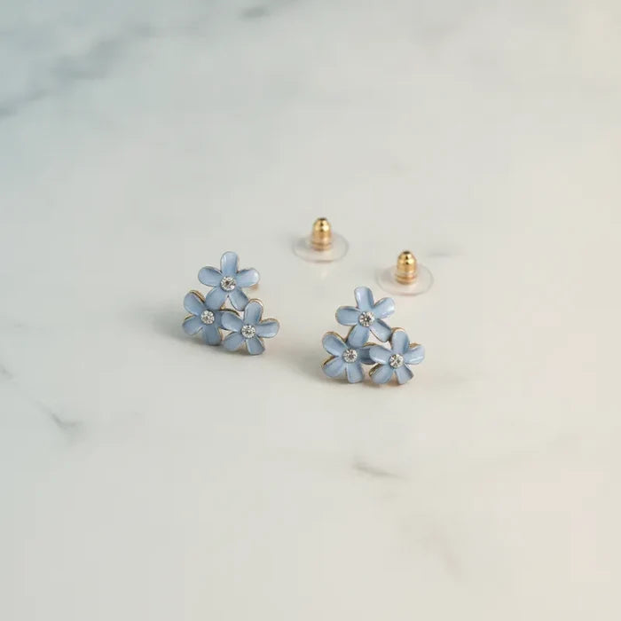 Dainty blue floral enamel stud earrings with clear crystal centers and gold-tone posts for elegant wear