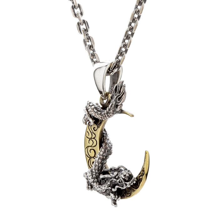 A side profile of the Eastern dragon pendant as it wraps around the brass moon.