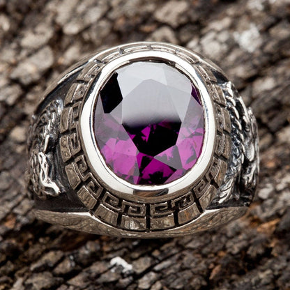 A sterling silver signet ring with a 5-carat amethyst, flanked by carvings of a dragon and tiger.